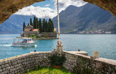 Perast, Montenegro - April 2018 : View of the small Church on San George`s island in Kotor bay as seen from the walls of Our Lady of the Rocks chapelのeditorial素材
