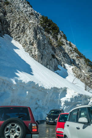 Lovcen National Park, Montenegro - April 2018 : Cars with tourists driving on a narrow road through the wonderful mountain scenery in winterのeditorial素材