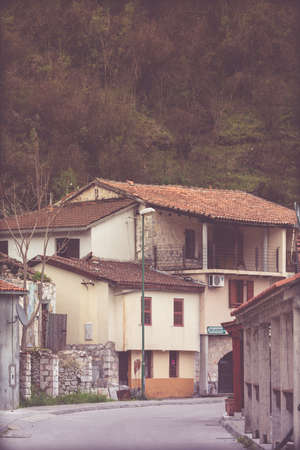 Rijeka Crnojevica, Montenegro - April 2018 : Narrow street between private homes in the old town of Rijeka Crnojevica on a rainy dayのeditorial素材