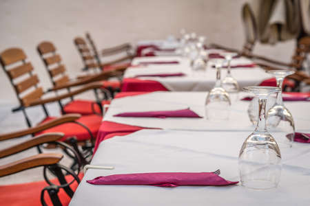 Wine glasses and cutlery on the table before the start of the service in the restaurantの写真素材