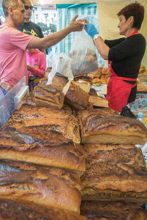 Jawor, Poland - July 2018 : People selling and buying freshly baked bread from a street stand during the annual Bread and Gingerbread Festivalのeditorial素材