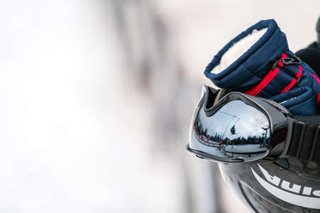 Ski helmet, gloves and ski poles left in the snow on the mountain slope in winterの写真素材