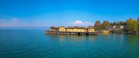 Panoramic view of the wooden pier leading to the Bay of the bones on water, authentic reconstruction of the pile dwelling settlement, Ohrid, Republic of Macedoniaの写真素材