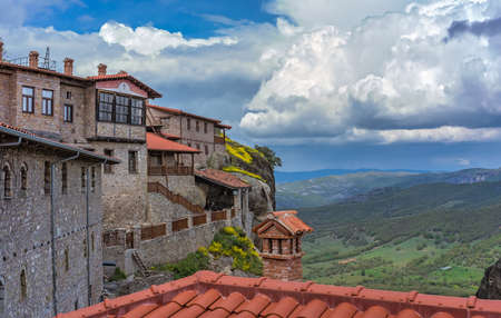 Red tiled rooftops of stunningly located on top of a rock Holy Monastery of Great Meteoron in...