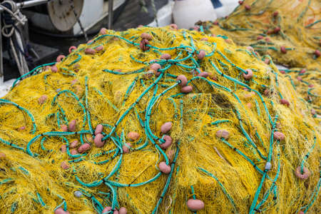 Tangled yellow fisherman fishing nets on the shore of in Zante Island, Greece