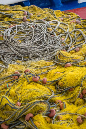 Tangled colorful fisherman fishing nets and ropes on the shore of in Zante Island, Greeceの写真素材