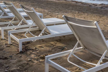 Empty white plastic sunbeds on Tsilivi Beach in summer on Zante Island, Greece