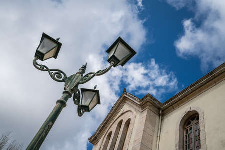 Three way lamppost in front of a small church in Agios Leon village, Zante, Greeceの写真素材