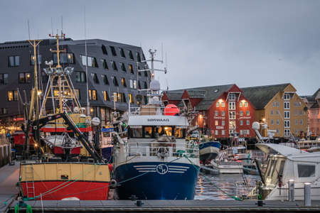 Tromso, Norway -  December 2018 : Boats in port and harbour in Tromsoysundet strait in Tromso in...
