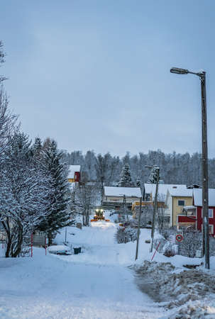 Powerful snowplough clearing residential roads in Tromso town in winter, Norwayの写真素材