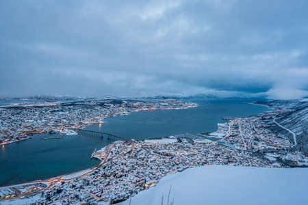 Aerial view to the city of Tromso in winter from the mountain ledge Storsteinen, 421 m above sea level , Northern Norwayの写真素材