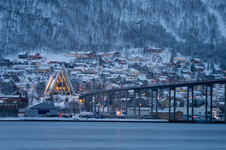 Arctic Cathedral with famous Tromso Bridge across Tromsoysundet strait in the background, Northern Norwayの写真素材