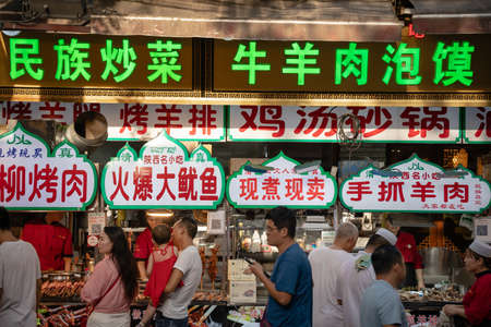 Xian, China -  July 2019 : Colorful and brightly illuminated and lit neons and shop boards in the popular street food district called Muslim Quarterのeditorial素材