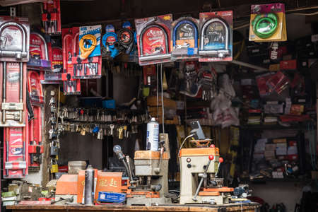 Xian, China -  July 2019 : Small Locksmith shop with bunches of keys hung on small hooks on the street in the Muslim Quarterのeditorial素材