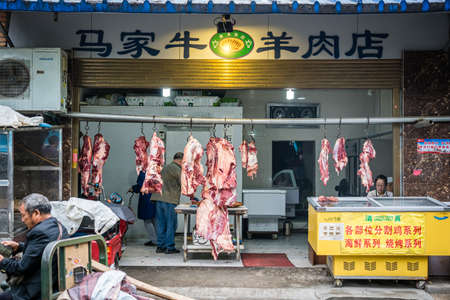 Xian, China -  July 2019 : Lamb and cow carcasses hanging on hooks in the Muslim quarter of Xian town, Shaanxi Provinceのeditorial素材
