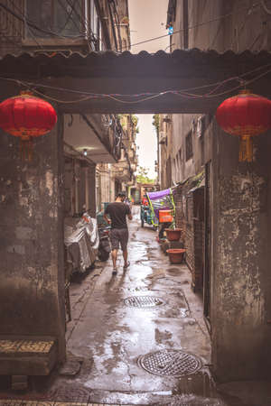Xian, China -  July 2019 : Man walking on a narrow street in Xian Old Town, Shaanxi Provinceのeditorial素材