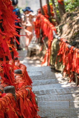 Red ribbons along trail in mountains in Zhangjiajieの写真素材