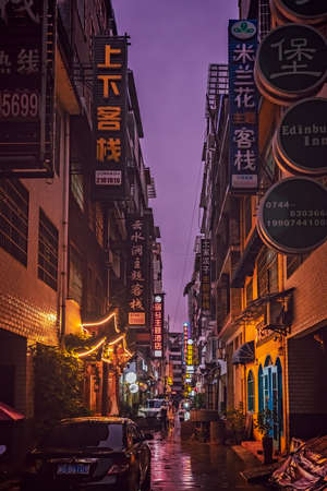 Zhangjiajie, China -  August 2019 : Narrow street in Zhangjiajie city during rainy night, Hunan Provinceのeditorial素材