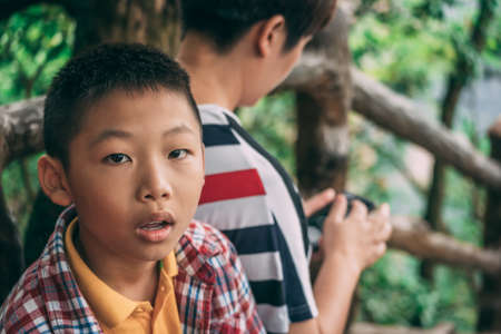 Zhangjiajie, China - August 2019 : Portrait of a young chinese boy on the viewpoint in Tianzi mountain range, Avatar mountains nature parkのeditorial素材