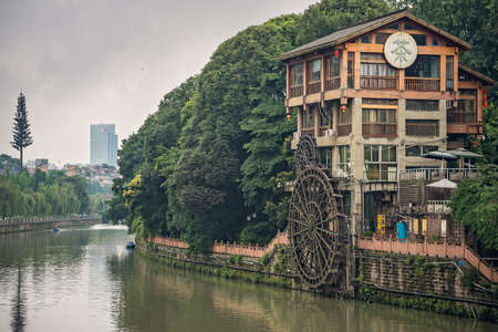 Chengdu, China -  July 2019 : Old mill building with big wooden wheel on the bank of Jin River flowing through Chengdu city, Sichuan Provinceのeditorial素材