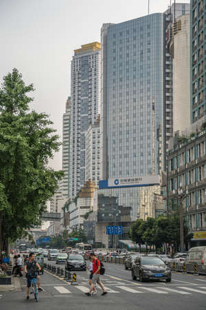 Chengdu, China -  July 2019 : People crossing the busy street in the commercial part of the city of Chengdu in summer, Sichuan Provinceのeditorial素材