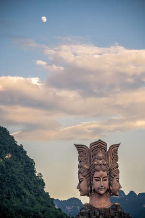 Wulingyuan, China -  August 2019 : Four faced sculpture at the entrance to the Romance Park located in Suoxiyu Town in Wulingyuan.  It is famous for the show of Zhangjiajie Romance performance.のeditorial素材