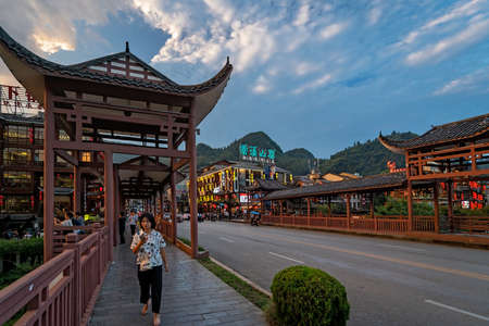 Wulingyuan, China -  August 2019 : Woman walking on the bridge in the ancient part of  townのeditorial素材