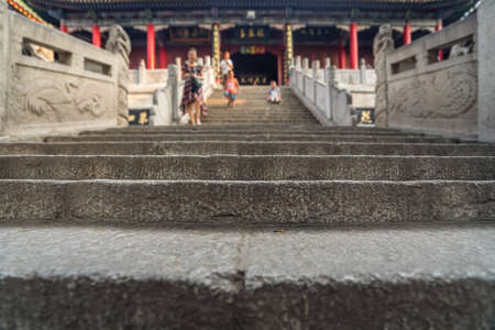 Unidentifiable people walking down the stairs leading to the Buddhist temple at the foot of Huashan mountain, Xian, Shaanxi Province, Chinaのeditorial素材