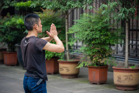 Chengdu, China - July 2019 : Chinese man praying and worshiping at the Wenshu Chinese Buddhist Templeのeditorial素材