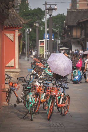 Chengdu, China -  July 2019 : Street scene in the city of Chengdu in summer, parked public use bicycles, Sichuan Provinceのeditorial素材