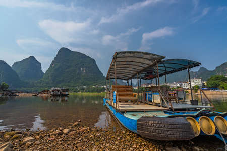 Yangshuo, China - August 2019 : Small tourist and fishermen boats on the Li river shore, the ferry crossing point in Yangshuoのeditorial素材