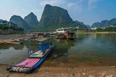 Yangshuo, China - August 2019 : Small tourist and fishermen boats on the Li river shore, the ferry crossing point in Yangshuoのeditorial素材
