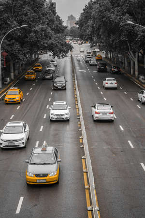 Xian, China -  August 2019 : Taxis and traffic on a busy road lanes in the city of Xian in summer, Shaanxi Provinceのeditorial素材