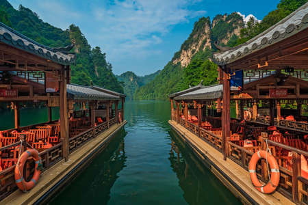 Wulingyuan, China -  August 2019 : Tourist boats waiting for passengers on the lakeshore of Baofeng Lake, Zhangjiajie National Forest Park, Hunan Province, China, Asiaのeditorial素材