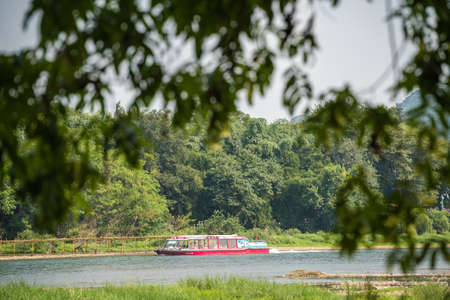 Guilin, China -  August 2019 : Small local passenger boat sailing on the magnificent Li river from Guilin to Yangshuoのeditorial素材