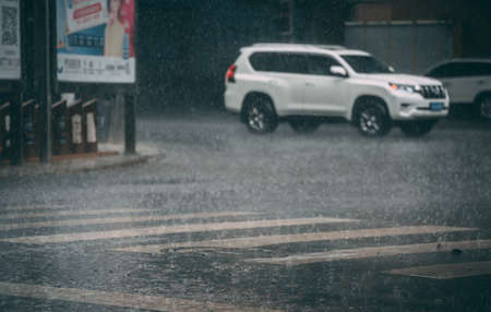 Chengdu, China - July  2019 : Zebra crossing full of water during tropical monsoon rain in Chengdu, Sichuan provinceのeditorial素材