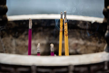 Large bronze brass pot with incense sticks burning inside in the courtyard of the Buddhist temple at the top of West Peak on Huashan mountain, Xian, Shaanxi Province, Chinaの写真素材