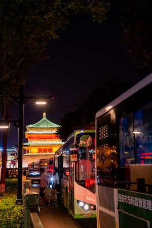 Xian, China -  July 2019 : Public buses stopping in front of the landmark Drum Tower at night, Shaaxi Provinceのeditorial素材