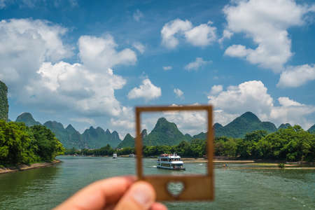 Li River, China - August 2019 : Sightseeing boat full of tourists in a frame on a trip on the magnificent Li river from Guilin to Yangshuoのeditorial素材