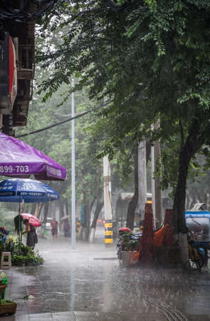Chengdu, China - July  2019 : Empty street and pavement during tropical monsoon rain in Chengdu, Sichuan provinceのeditorial素材
