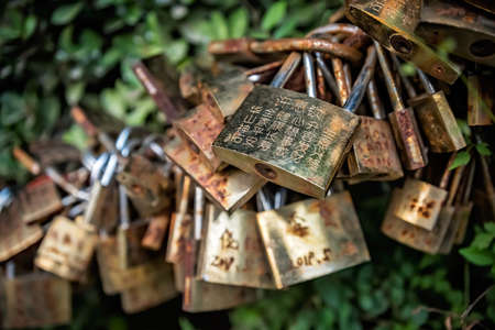 Huashan, China -  August 2019 : Memorial padlocks tied to the barriers along the walking rail path in Huashan mountain,  Shaanxi Provinceのeditorial素材