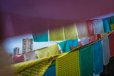 Zigong, China -  July 2019 : Buddhist prayer flags fluttering in the wind on the roof of a residential block of flats in Zigong, Sichuan Provinceのeditorial素材