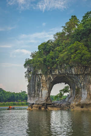 Guilin, China - August 2019 : Tourists in water next to the landmark Elephant Trunk Hill Arch and the Li River Lijiang River, Guangxi Provinceのeditorial素材