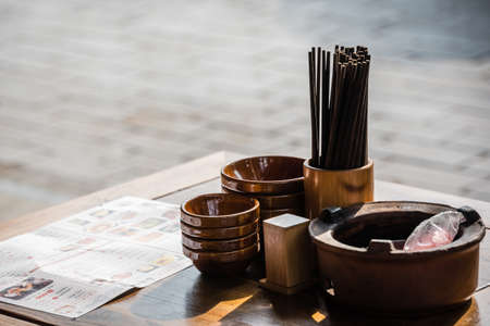 Wulingyuan, China - August 2019 : Ceramic bowls and wooden chopsticks on the table before the start of the service in the Chinese restaurantのeditorial素材