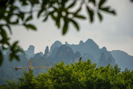 Wulingyuan, China - August 2019 : Stunningly beautiful rocky karst mountain formations as seen from the centre of Wulingyuan town, Hunan Provinceのeditorial素材