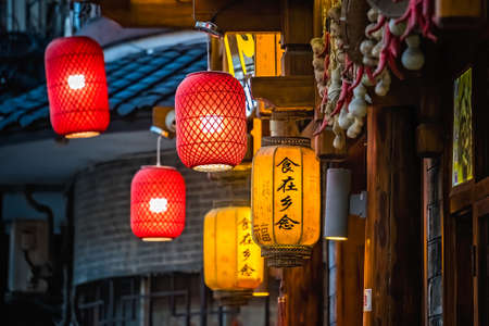 Wulingyuan, China -  August 2019 : Variety of colourful Chinese Paper Lanterns hanging from buildings in a streetのeditorial素材