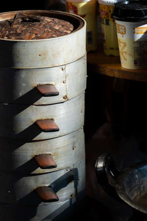 Feng Huang, China - August 2019 : Cooking untensils and containers used to prepare telicious traditional chinese Baozi buns, steamed buns filled with ground pork meat and cabbage prepared on hot steam, steamedのeditorial素材