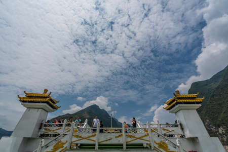 Yangtze River, China - August 2019 : tourists standing on the viewing platform on the top deck of the luxury passenger cruise ship sailing through the gorgeのeditorial素材