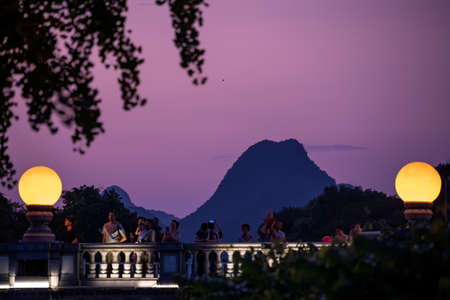 Guilin, China -  August 2019 : People on the road Bridge over the estuary of Rong and Shan Lakes at night, Guilin town, Guangxi Provinceのeditorial素材
