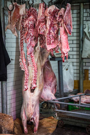 Xian, China -  August 2019 : Lamb and cow carcass meat hanging on a hook on the street food vendors shop in the Muslim quarter of Xian town, Shaanxi Provinceのeditorial素材